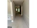 Unfinished hallway with a high ceiling and walls ready to paint at 115 Yancey Rd, Covington, GA 30014