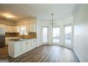 Bright kitchen with island, granite counters, and hardwood floors at 13 Forest Ridge Ct, Sandy Springs, GA 30350