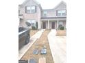 Brick townhouse exterior with driveway and small front yard at 6258 Ellenwood Dr, Rex, GA 30273