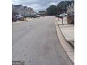 Residential street view showcasing townhouses and parked cars at 6258 Ellenwood Dr, Rex, GA 30273