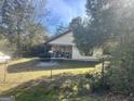 Yellow ranch home with a covered porch and grill at 3449 Highway 138 Ne, Conyers, GA 30013
