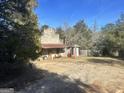 Rustic stone building with gas pump and outbuildings at 3449 Highway 138 Ne, Conyers, GA 30013