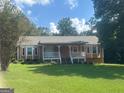 Ranch style home with a covered porch and a spacious yard at 216 Rivers Rd, Fayetteville, GA 30214