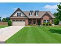 Brick home with a two-car garage and landscaped lawn at 417 Creekside Park, Covington, GA 30014