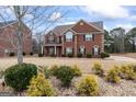 Two-story house with a brick facade and mature landscaping at 801 Carnegie Ct, Locust Grove, GA 30248