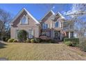 Two-story home with a large front porch and American flag at 3443 Pinemont Dr, Douglasville, GA 30135