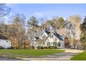 Two-story house with green shutters, a driveway and a spacious yard at 180 Rock Hill Dr, Fayetteville, GA 30215