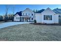 White two-story farmhouse with dark gray accents and a welcoming front porch at 145 Dockside Dr # 396, Fayetteville, GA 30215