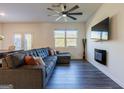 Spacious living room with L-shaped sectional sofa and electric fireplace at 177 Swindon Dr, Mcdonough, GA 30253