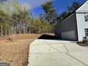 Long concrete driveway leading to an attached garage, with trees in the background at 2791 Riverchess Ct # 147, Atlanta, GA 30331