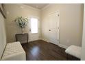 Spacious foyer with bench, decorative vase, and dark hardwood floors at 316 Trulove Lane Lot 35 # 35, Locust Grove, GA 30248