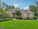 Brick home with a lush green lawn at 418 Branch Forest Way, Stockbridge, GA 30281