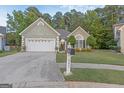 House exterior showcasing a two-car garage and landscaping at 245 Woodstream Way, Fayetteville, GA 30214