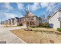 Two-story house on a tree-lined street with a front yard and sidewalk at 11945 Lovejoy Crossing Way, Hampton, GA 30228