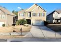 Charming two-story brick home featuring a two-car garage and professionally landscaped front yard at 5150 Amberland Sq, Atlanta, GA 30349