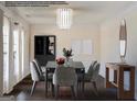 Modern staged dining room, featuring a dark wood table and gray chairs at 303 Roundwood Way, Peachtree City, GA 30269