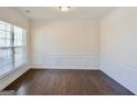 Bright dining room with hardwood floors and wainscoting at 303 Roundwood Way, Peachtree City, GA 30269