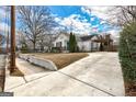 Front view of a white house with a driveway and landscaping at 522 Lake Dr, Hapeville, GA 30354