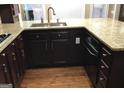 Kitchen boasts granite countertops and dark wood cabinets at 430 Lake Dylan Ct, Fairburn, GA 30213