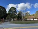 Gated entrance to the property with brick columns and landscaping at 3970 Ewing Rd, Austell, GA 30106