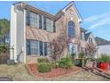 Brick two-story house with a landscaped yard at 123 Courtneys Ln, Fayetteville, GA 30215