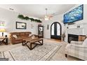 Inviting living room featuring a fireplace, ceiling fan, and stylish decor throughout at 3806 Bill Gardner Pkwy, Locust Grove, GA 30248