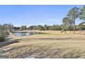 Landscaped golf course with pond and trees in background at 2984 Walt Stephens Rd, Jonesboro, GA 30236