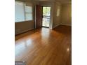 Hardwood floor living room with neutral walls and a view of the front door at 1310 Celia Way, Decatur, GA 30032