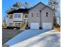 Two-story house with gray siding, white accents, and a three-car garage at 3279 Greenhill Dr, Villa Rica, GA 30180