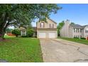 Two-story house with a two-car garage and large front yard at 5260 Shirewick Dr, Lithonia, GA 30058