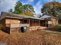 Home features a deck, grassy yard, and storage building at 213 Whippoorwill Way, Riverdale, GA 30274