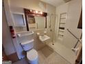 Bathroom with toilet, sink, shower, and grab bars at 213 Whippoorwill Way, Riverdale, GA 30274