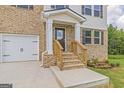 Brick house entrance with wooden stairs and railing at 760 Great Oak Pl # 22, Villa Rica, GA 30180