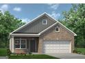 Inviting home with brick facade, two-car garage, beautiful lawn, and a timeless aesthetic at 1467 Trellis Court (Lot 5), Hampton, GA 30228