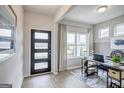 Bright foyer with modern front door, neutral walls, and a view into a home office with a large window at 1479 Trellis Court (Lot 3), Hampton, GA 30228