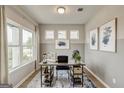 Well-lit home office featuring neutral decor, modern art, and a view of the outdoors from the large window at 1479 Trellis Court (Lot 3), Hampton, GA 30228