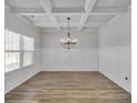 Formal dining room with coffered ceiling and chandelier at 5626 Wyncreek Sw Cir, South Fulton, GA 30331