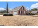 Side view of a brick house with attached garage at 600 English Ct, Mcdonough, GA 30252