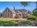 Beautiful brick home featuring a well-maintained lawn and established shrubbery at 600 English Ct, Mcdonough, GA 30252