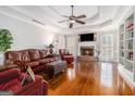 Spacious living room with hardwood floors, fireplace and built in shelving at 600 English Ct, Mcdonough, GA 30252