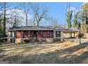 Red brick ranch house with mature trees at 5546 Stoneybrook Se Ct, Mableton, GA 30126