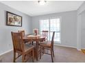 Traditional dining room with a round table, four chairs, neutral walls and lots of natural light at 2618 Windage Sw Dr, Marietta, GA 30008