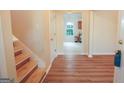 Bright and spacious entryway with wood-look floors and views to the kitchen at 4408 Idlewood Park, Lithonia, GA 30038