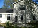 Rear view of a house with a patio and mature trees at 4408 Idlewood Park, Lithonia, GA 30038