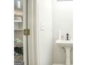 Small, modern bathroom with pedestal sink and gray flooring at 6527 Arbor Gate Sw Dr # Bldg 12, Mableton, GA 30126