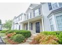 Two-story townhome with gray and white siding, black shutters, and landscaping at 6527 Arbor Gate Sw Dr # Bldg 12, Mableton, GA 30126