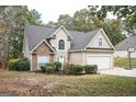 Two-story house with stone accents and a two-car garage at 308 Royal Crescent Way, Stockbridge, GA 30281