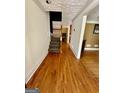 Hardwood floors and staircase in the home's entryway at 2735 Sandy Creek Cir, Loganville, GA 30052