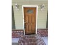 Wood front door with glass accents and brick entryway at 4020 Grady Smith Rd, Loganville, GA 30052