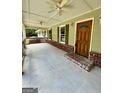 Covered front porch features ceiling fans and brick flooring at 4020 Grady Smith Rd, Loganville, GA 30052